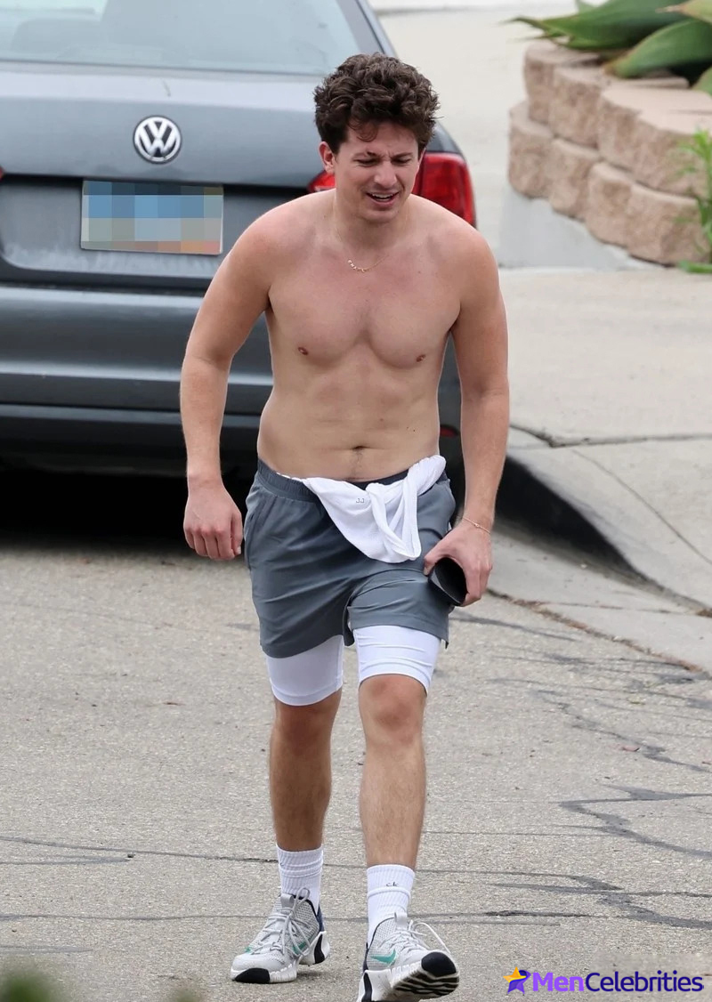 Charlie Puth shows off his naked torso while running