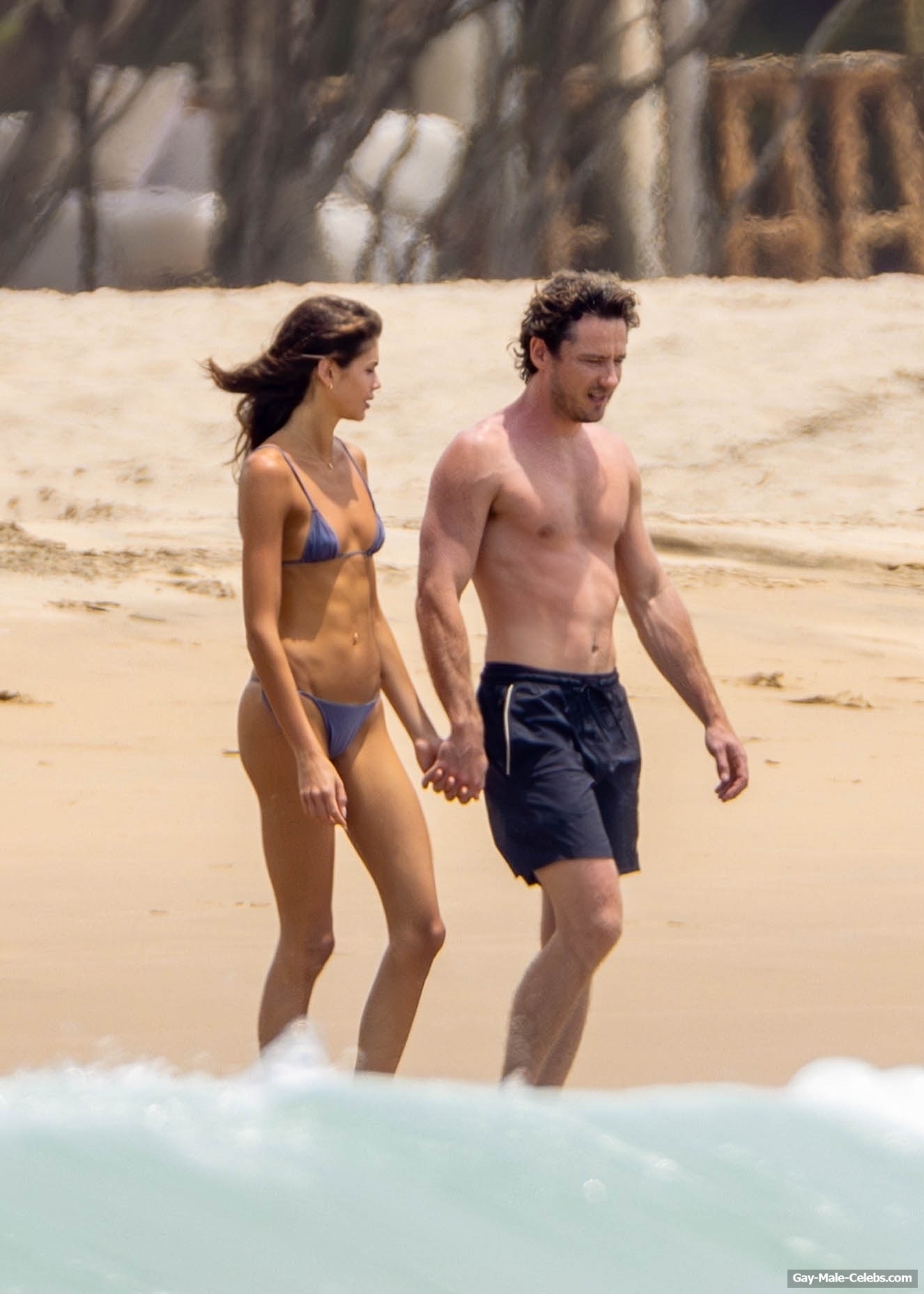 Lewis Pullman shirtless on a beach