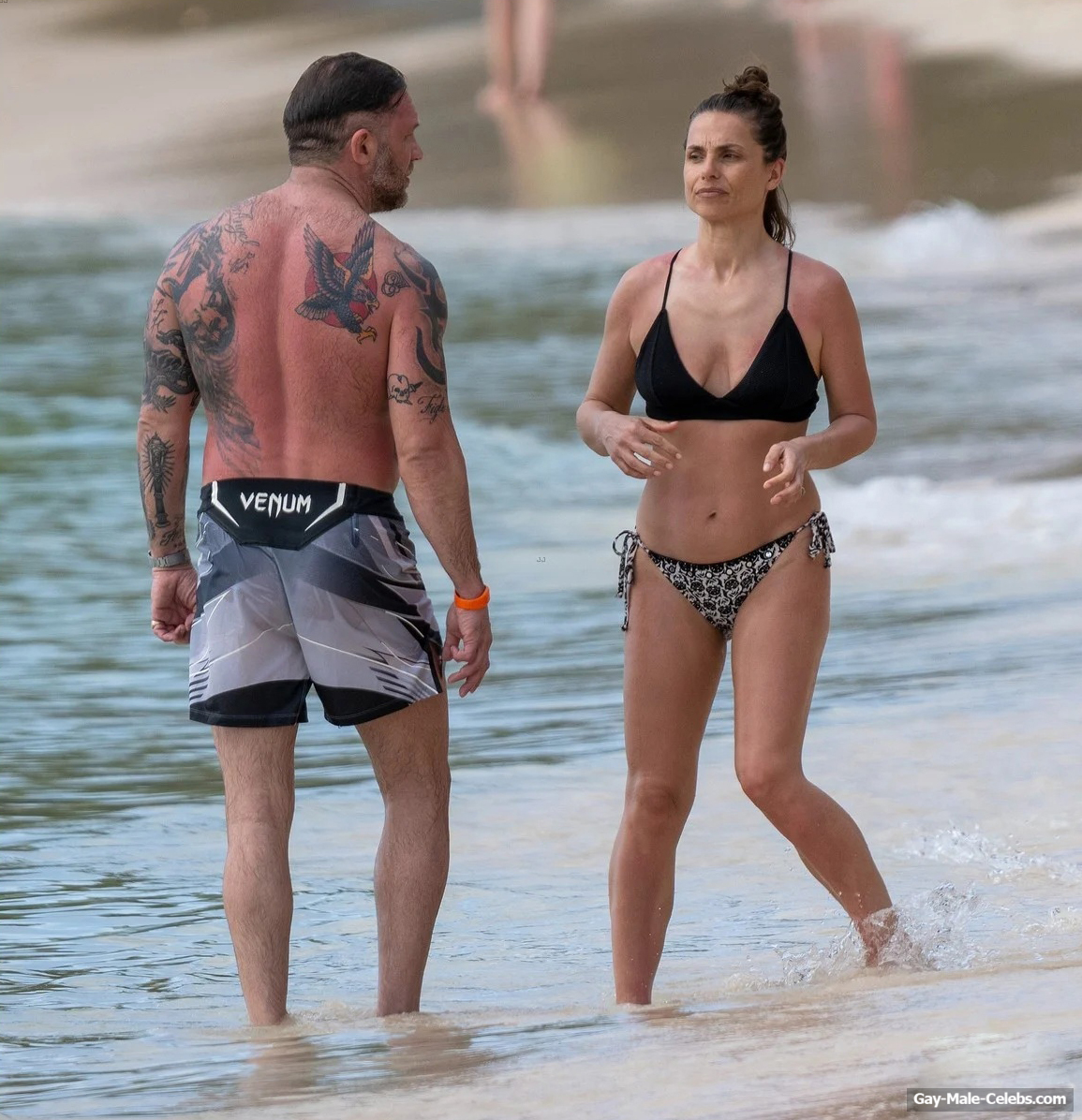 Tom Hardy shirtless on a beach