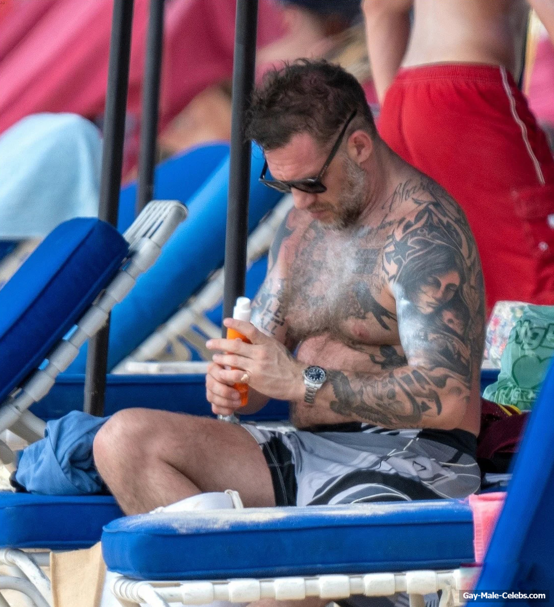 Tom Hardy shirtless on a beach