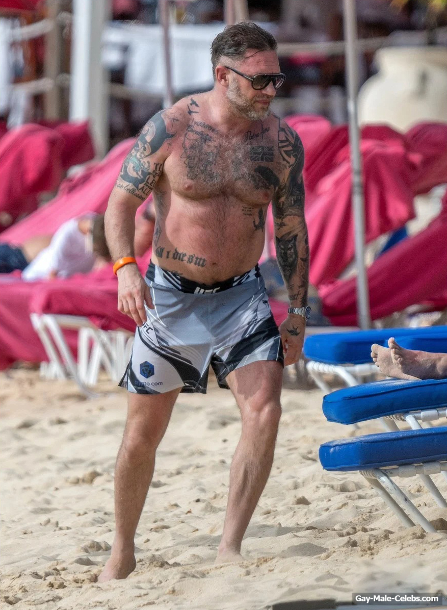 Tom Hardy shirtless on a beach